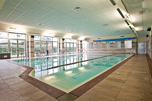 What are the advantages and constraints of an indoor swimming pool?